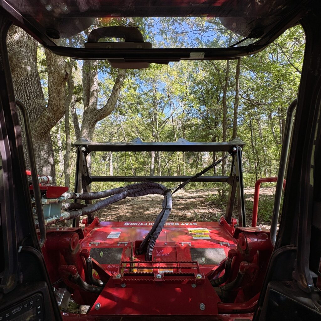 Inside Columbia Land Clearing's skid steer